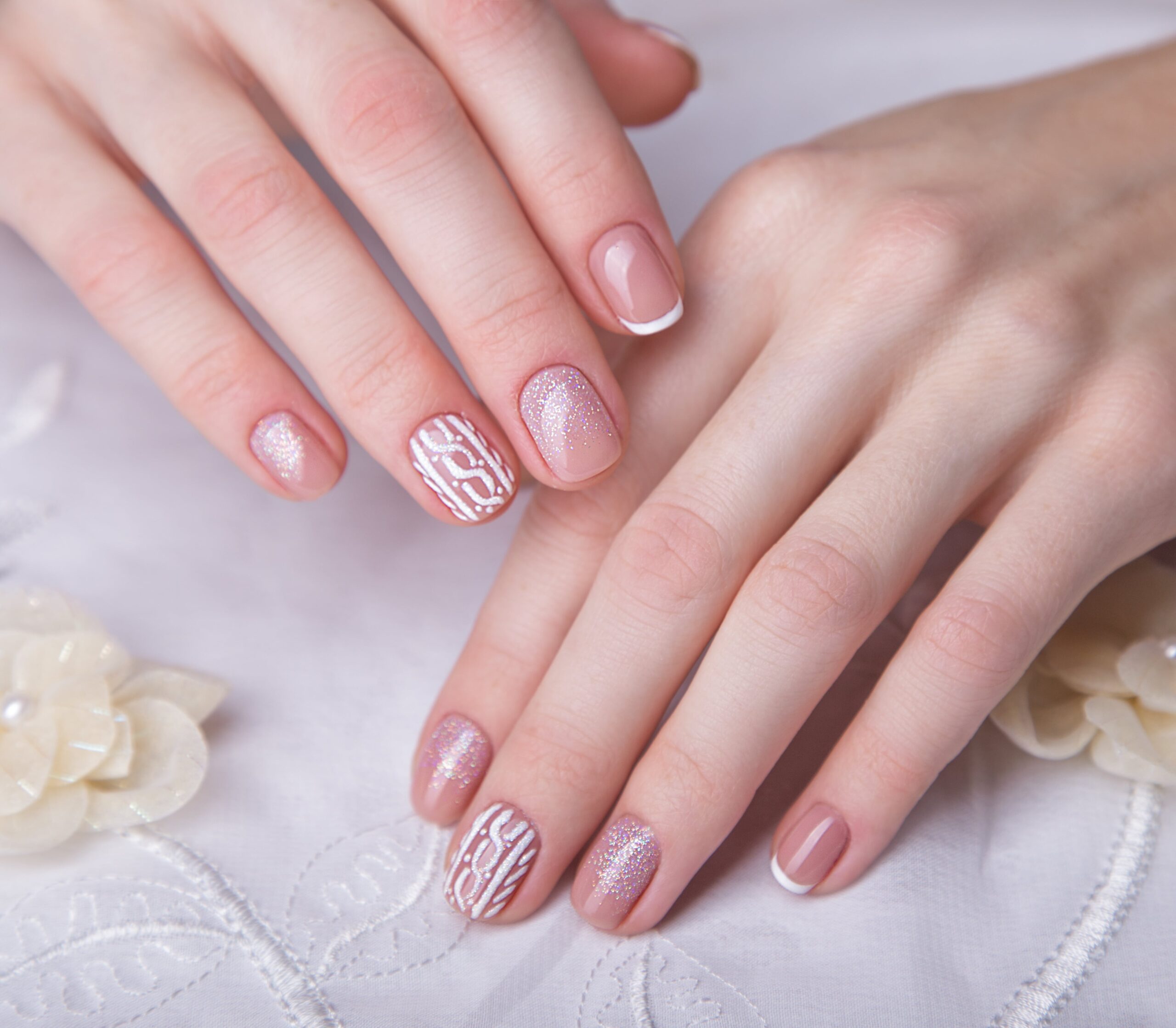 snow-white-manicure-female-hands-winter-nail-design-picture-taken-studio-min | JNY Nails